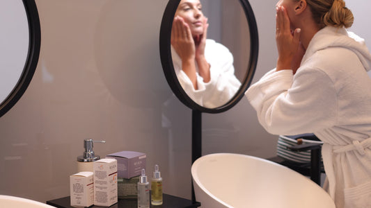 Woman doing her evening skincare routine at the mirror